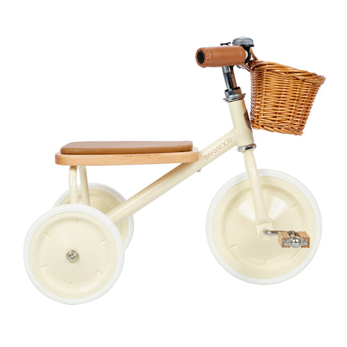 Children's balance bike with wooden seat and basket on a white background