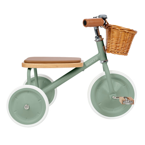 Green children's tricycle with a wooden seat and basket on a white background