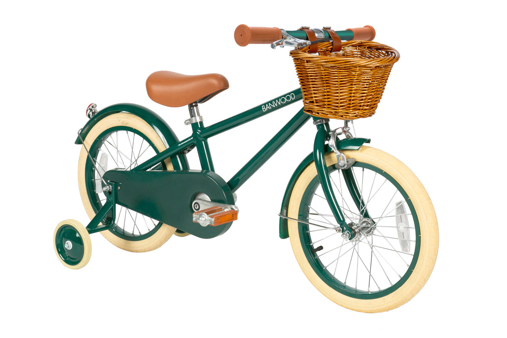 Children's bicycle with green frame and a basket on a white background